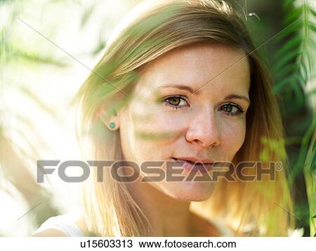 Stock Image - Portrait of young woman in nature. Fotosearch
