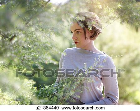 Stock Image - Portrait of young woman in nature. Fotosearch