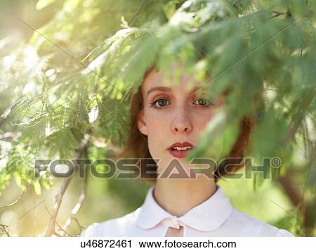 Stock Image - Portrait of young woman in nature. Fotosearch