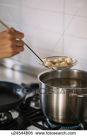 Potato gnocchi being removed from pot View Large Photo Image Stock Photography - Potato gnocchi being removed from pot. Fotosearch