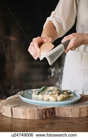 Potato gnocchi on plate being garnished View Large Photo Image Stock Photograph - Potato gnocchi on plate being garnished. Fotosearch