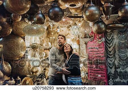 Stock Image - Pregnant couple in souk, Marrakech, Morocco. Fotosearch