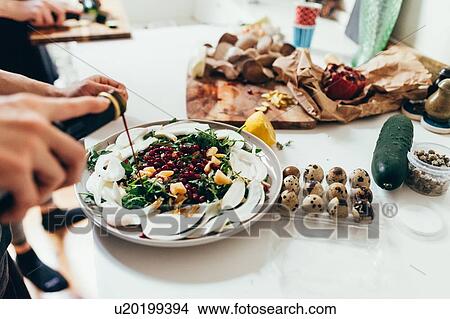 Picture - Preparing food in kitchen. Fotosearch