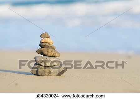 Picture - Pyramid of stones on a sandy beach.. Fotosearch