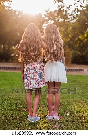 Stock Photography - Rear view of girls in park. Fotosearch