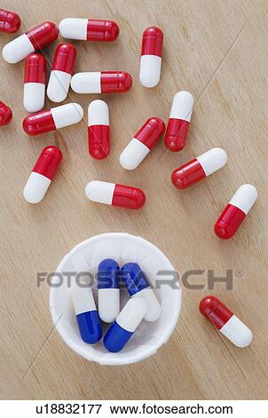 Stock Photo - Red and white and blue and white drug capsules.. Fotosearch