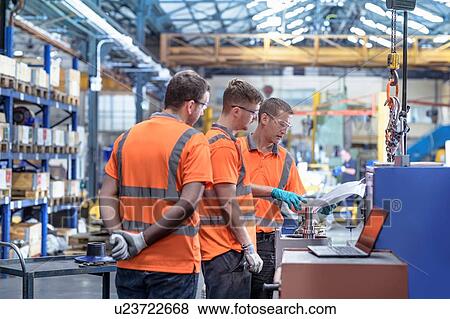Stock Photo - Repair team in meeting in gearbox factory. Fotosearch