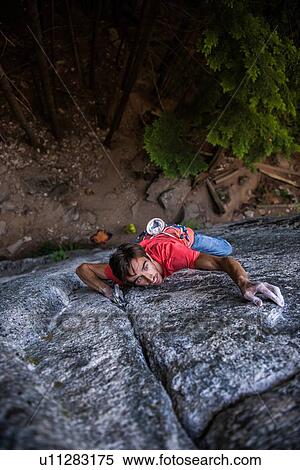 Stock Photography - Rock climber scaling rock face, Squamish, Canada. Fotosearch