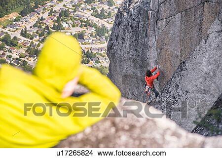 Picture - Rock climber waiting for team mate, Squamish, Canada. Fotosearch
