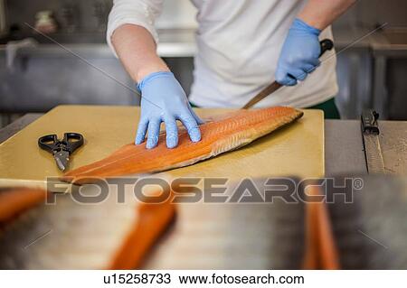 Salmon being prepared in smokehouse kitchen View Large Photo Image Stock Image - Salmon being prepared in smokehouse kitchen. Fotosearch