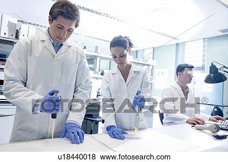 Stock Photo - Scientists using pipettes in the laboratory.. Fotosearch