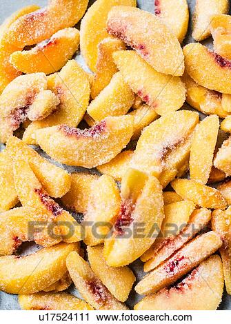 Stock Image - Sliced frozen peaches. Fotosearch