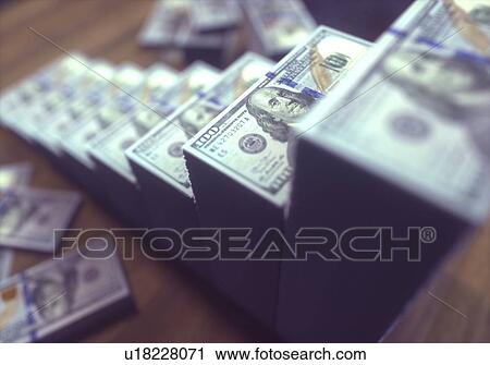 Stock Image - Stacks of one hundred US dollar banknotes, illustration.. Fotosearch