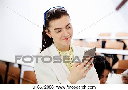 Student using cellphone in classroom View Large Photo Image Stock Photo - Student using cellphone in classroom. Fotosearch