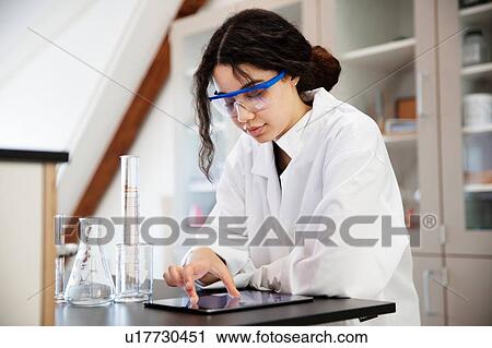 Student using digital tablet in laboratory View Large Photo Image Stock Image - Student using digital tablet in laboratory. Fotosearch