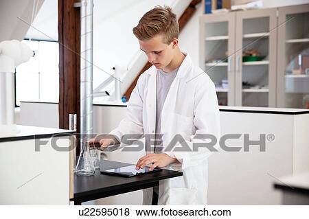 Student using digital tablet in laboratory View Large Photo Image Stock Photo - Student using digital tablet in laboratory. Fotosearch