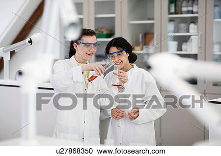 Students pouring sample into flask in laboratory View Large Photo Image Stock Image - Students pouring sample into flask in laboratory. Fotosearch