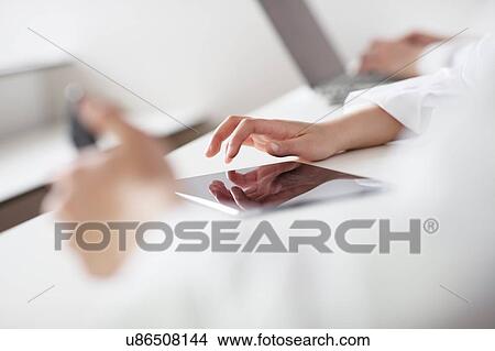 Students using digital tablet in classroom View Large Photo Image Picture - Students using digital tablet in classroom. Fotosearch