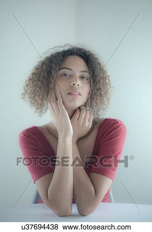 Stock Photo - Studio portrait of beautiful young woman. Fotosearch