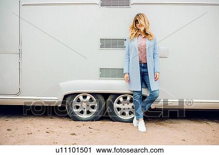 Stylish woman with long blond hair wearing sunglasses leaning against bus, portrait View Large Photo Image Stock Image - Stylish woman with long blond hair wearing sunglasses leaning against bus, portrait. Fotosearch