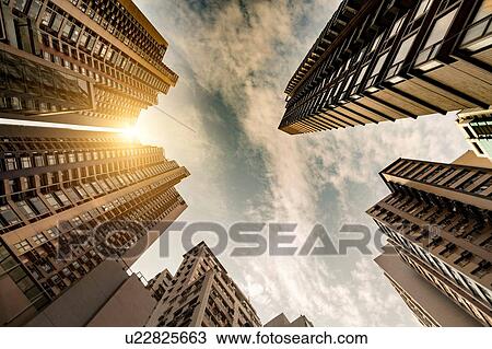 Stock Image - Sunset on Hong Kong skyscraper skyline. Fotosearch