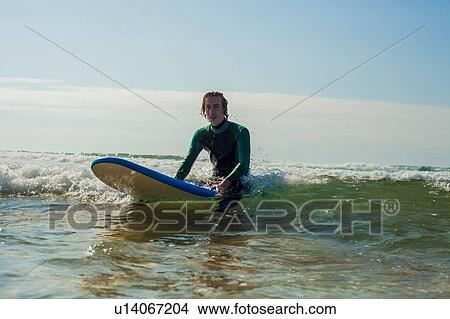 Picture - Surfer gliding on ocean wave, Watergate Bay, Cornwall, UK. Fotosearch