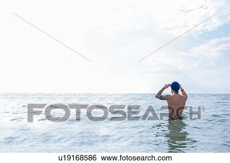Stock Photograph - Swimmer getting ready to go into sea. Fotosearch