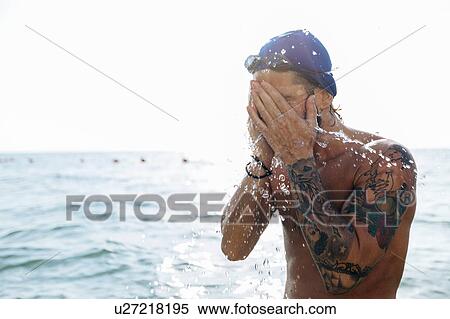 Swimmer splashing sea water on face View Large Photo Image Stock Photography - Swimmer splashing sea water on face. Fotosearch
