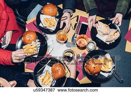 Table of burger and chips meal View Large Photo Image Stock Photo - Table of burger and chips meal. Fotosearch