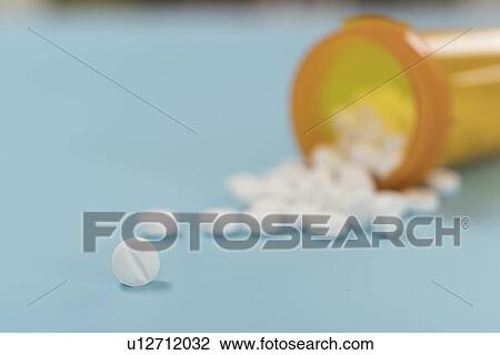 Tablets spilling from bottle. View Large Photo Image Stock Image - Tablets spilling from bottle.. Fotosearch
