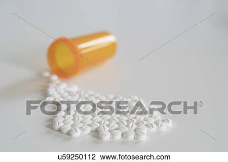 Tablets spilling from bottle. View Large Photo Image Stock Image - Tablets spilling from bottle.. Fotosearch