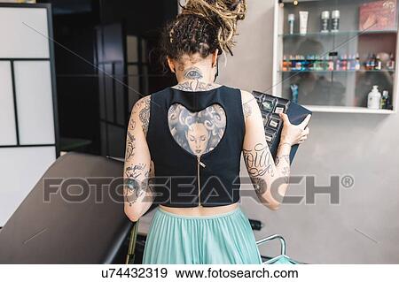 Stock Photo - Tattooist in parlour. Fotosearch