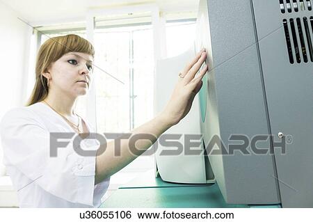 Stock Photograph - Technician working autoclave.. Fotosearch