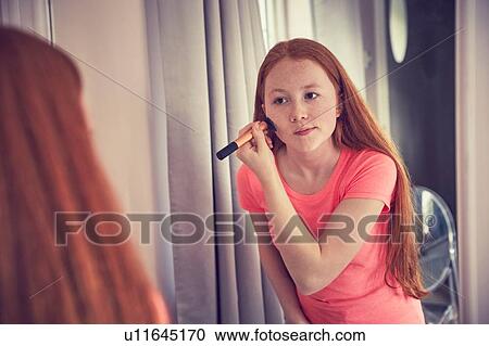 Teenage girl putting on make-up View Large Photo Image Stock Image - Teenage girl putting on make-up. Fotosearch