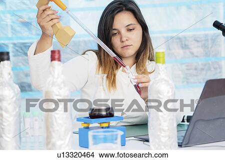 Testing wine in quality control lab. View Large Photo Image Picture - Testing wine in quality control lab.. Fotosearch