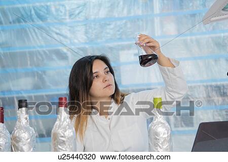 Stock Image - Testing wine in quality control lab.. Fotosearch
