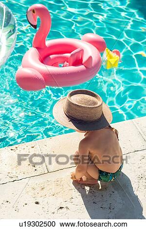 Stock Image - Toddler at swimming pool in summer. Fotosearch