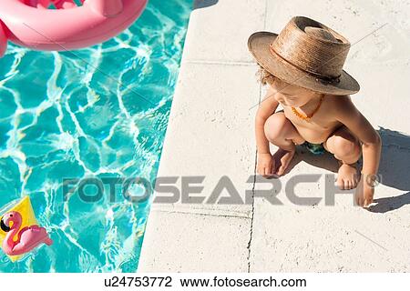 Stock Image - Toddler at swimming pool in summer. Fotosearch