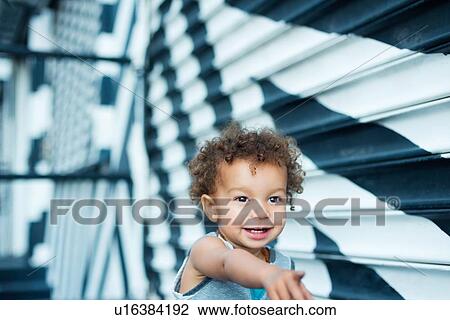 Stock Image - Toddler pointing, mural in background, Wynwood, Miami, Florida, USA. Fotosearch