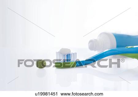 Toothbrush with a pea sized amount of toothpaste against a white background. View Large Photo Image Stock Image - Toothbrush with a pea sized amount of toothpaste against a white background.. Fotosearch