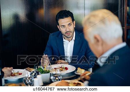 Two businessmen having meeting in hotel restaurant View Large Photo Image Stock Photo - Two businessmen having meeting in hotel restaurant. Fotosearch