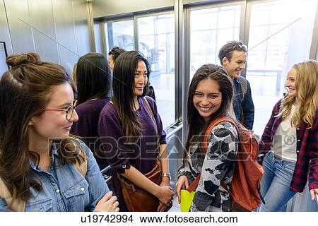 University students talking inside elevator View Large Photo Image Picture - University students talking inside elevator. Fotosearch