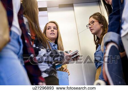 University students talking inside elevator View Large Photo Image Stock Image - University students talking inside elevator. Fotosearch