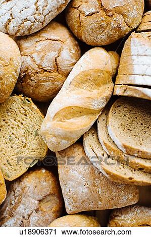 Stock Image - Variety of brown and wholemeal breads, overhead view. Fotosearch
