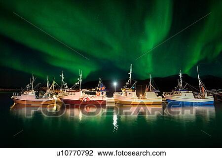 Stock Image - Vengsoy, traditional Norwegian fishing boats at northern lights, Troms, Troms, Norway. Fotosearch