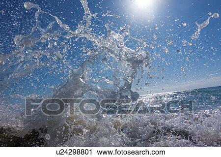 Waves crashing against rocks. View Large Photo Image Stock Image - Waves crashing against rocks.. Fotosearch