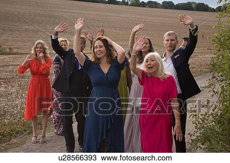 Wedding guests waving off newlyweds View Large Photo Image Stock Image - Wedding guests waving off newlyweds. Fotosearch