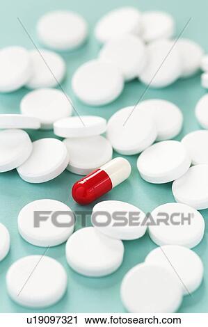 White pills surrounding a red and white capsule. View Large Photo Image Stock Image - White pills surrounding a red and white capsule.. Fotosearch