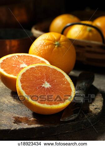 Picture - Whole and half oranges. Fotosearch