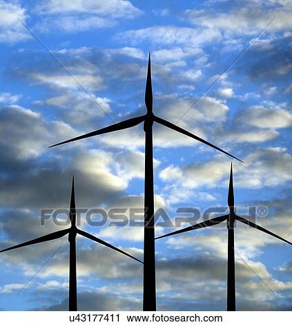 Stock Image - Wind turbines against clouds.. Fotosearch